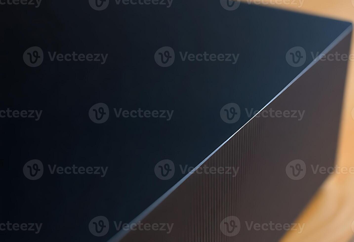 close up of a black speaker on a wooden surface photo