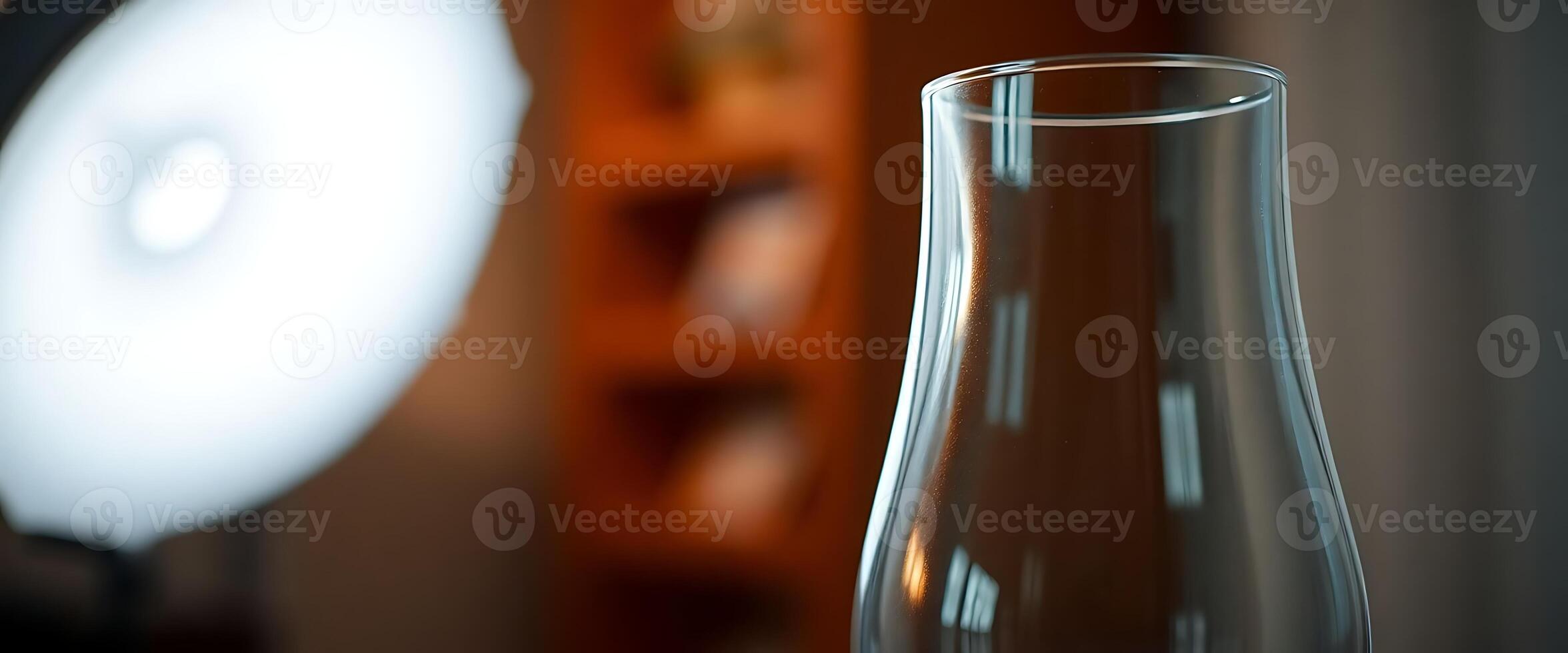 vase sitting on a table next to a lamp photo