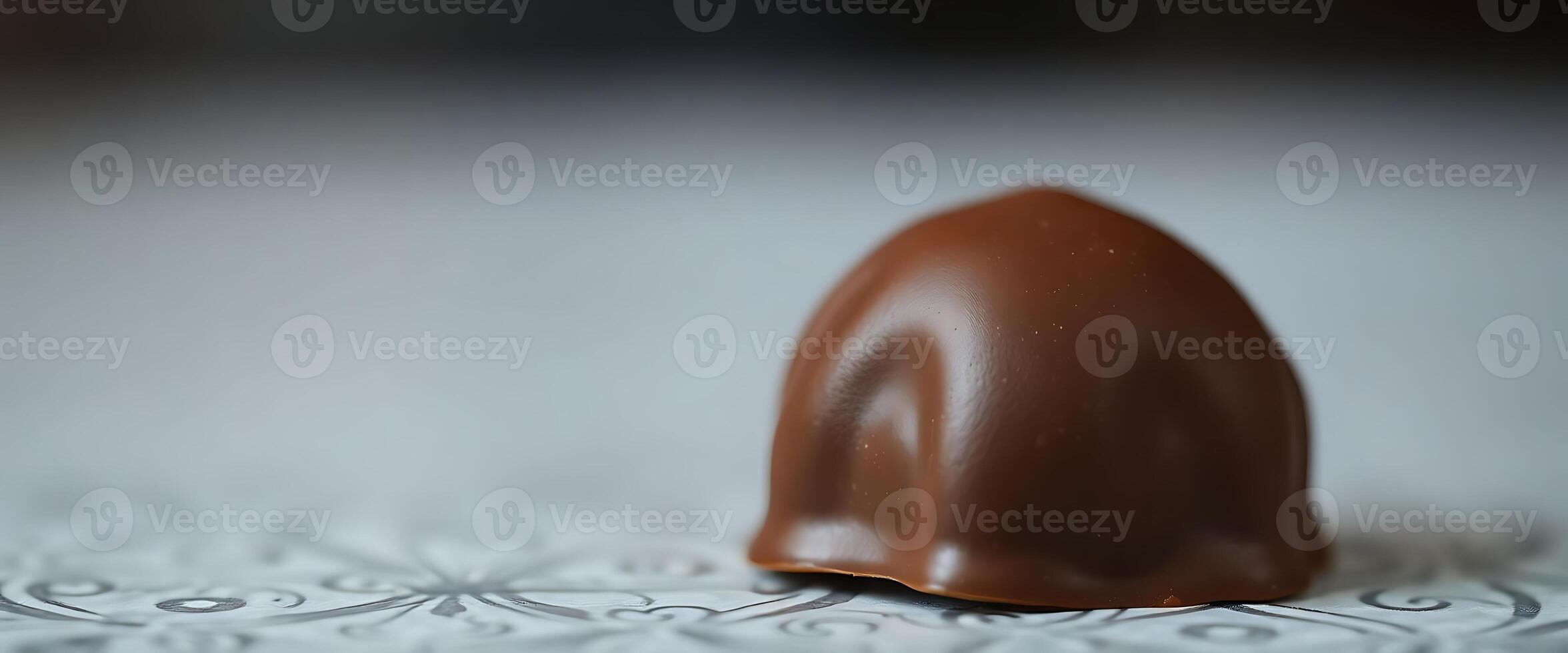 A chocolate egg sitting on top of a white table photo