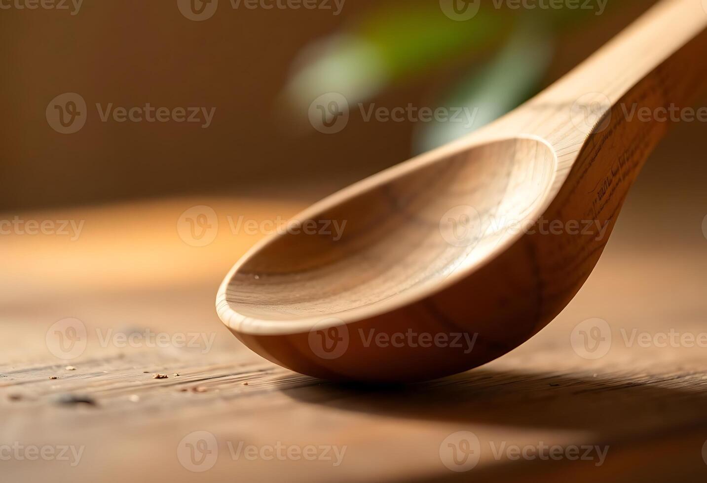 A wooden spoon sitting on a wooden table photo