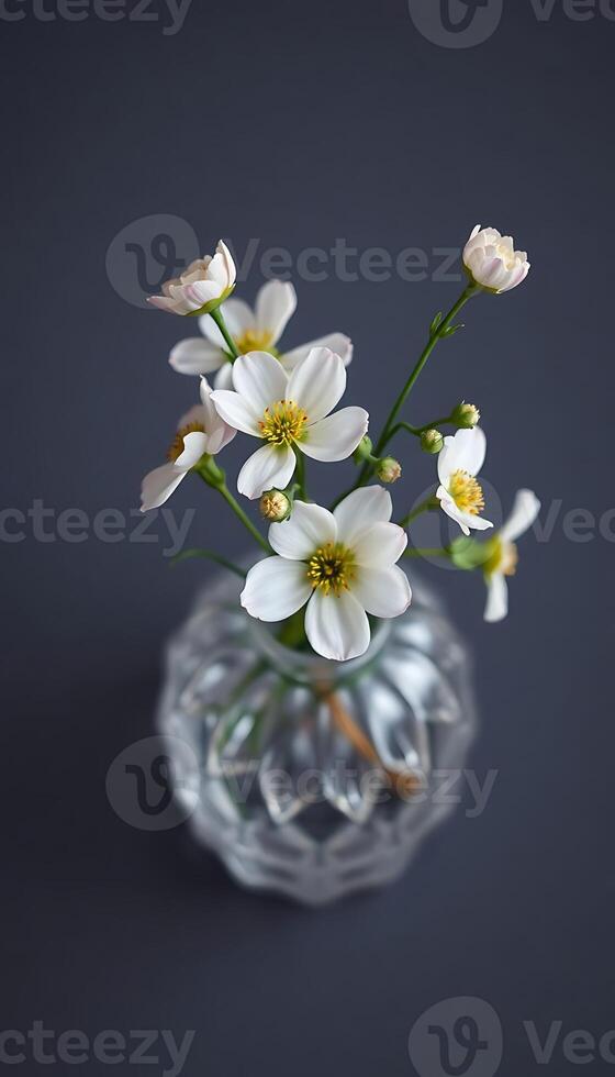 glass vase filled with white flowers on top of a table photo