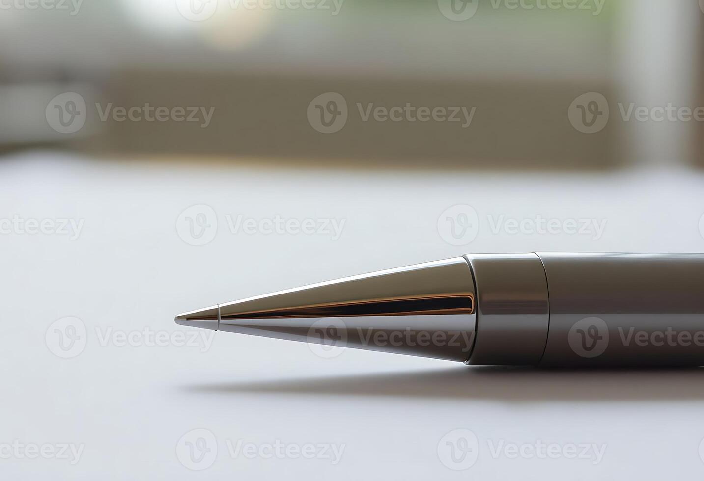 A pen sitting on top of a white surface photo