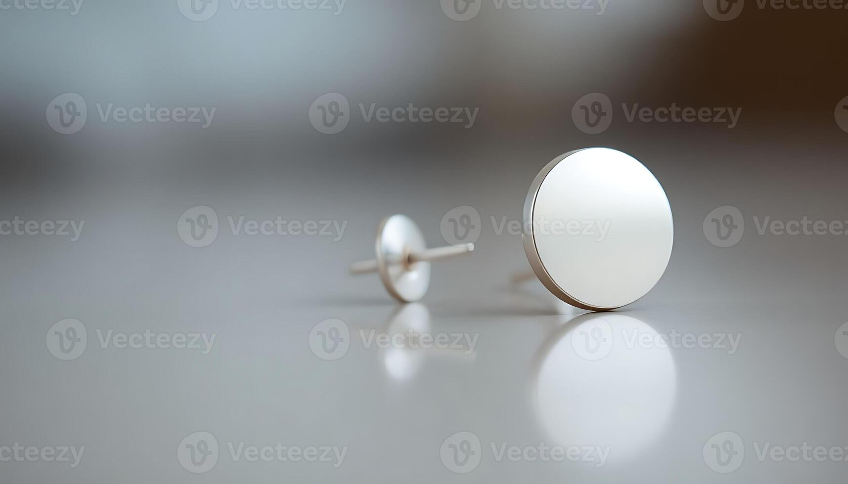pair of white earrings sitting on top of a table photo