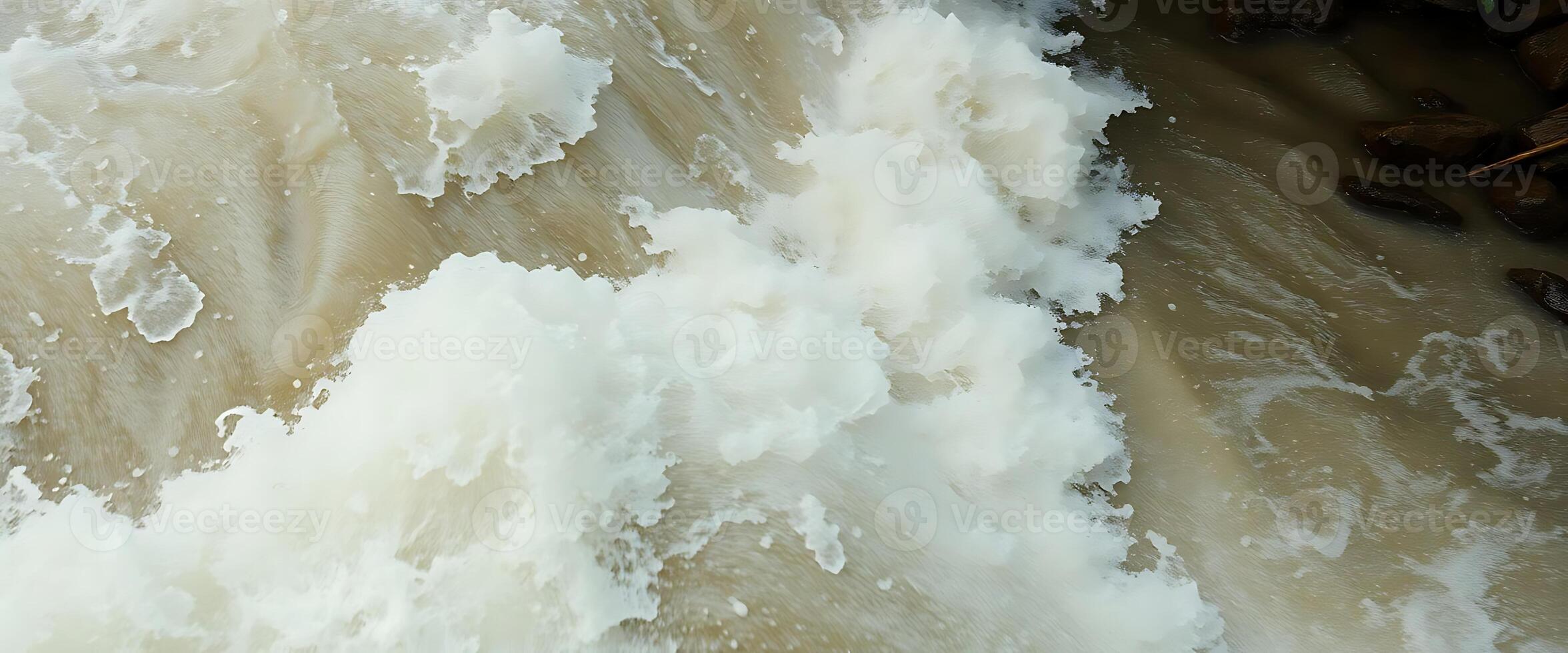 A man is riding a surfboard in a river photo