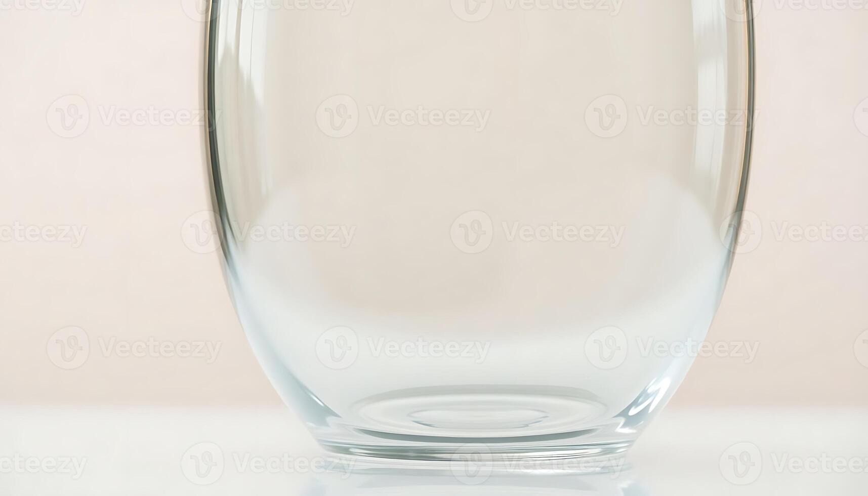 A clear glass vase on a white surface photo