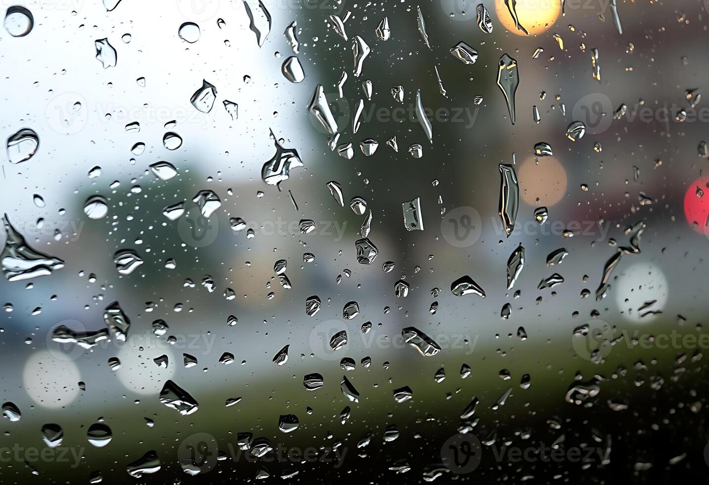 A view of a car driving down the road with rain drops on the window photo
