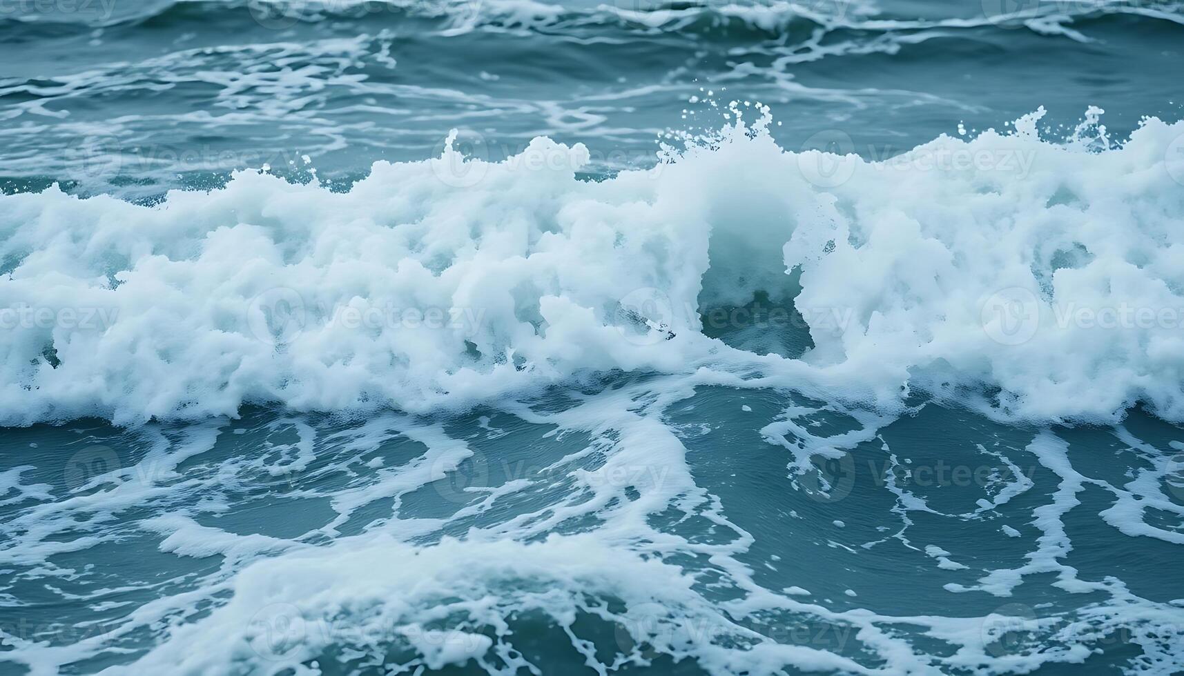 A close up of a wave breaking on the ocean photo