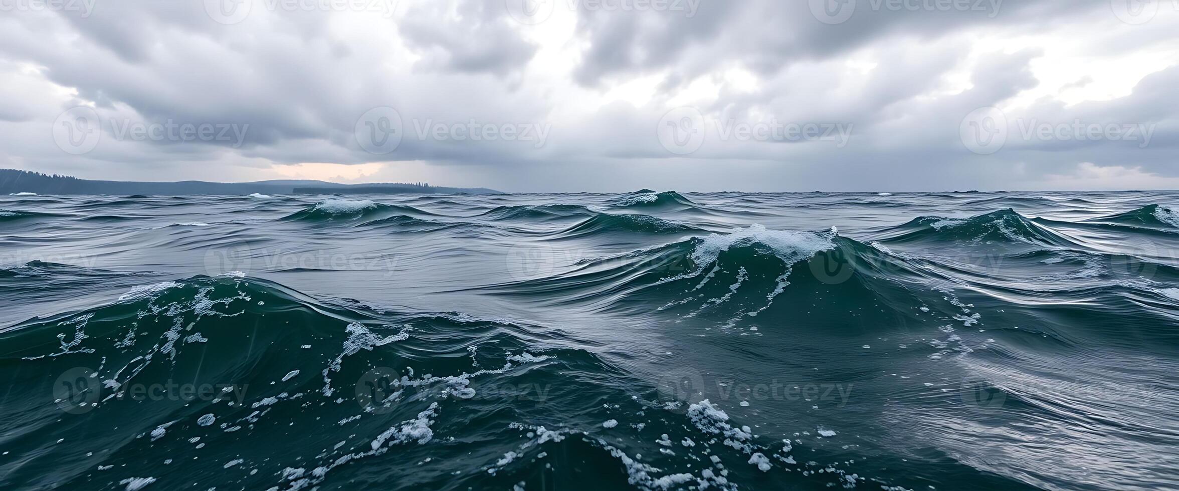 A view of the ocean with waves and clouds photo
