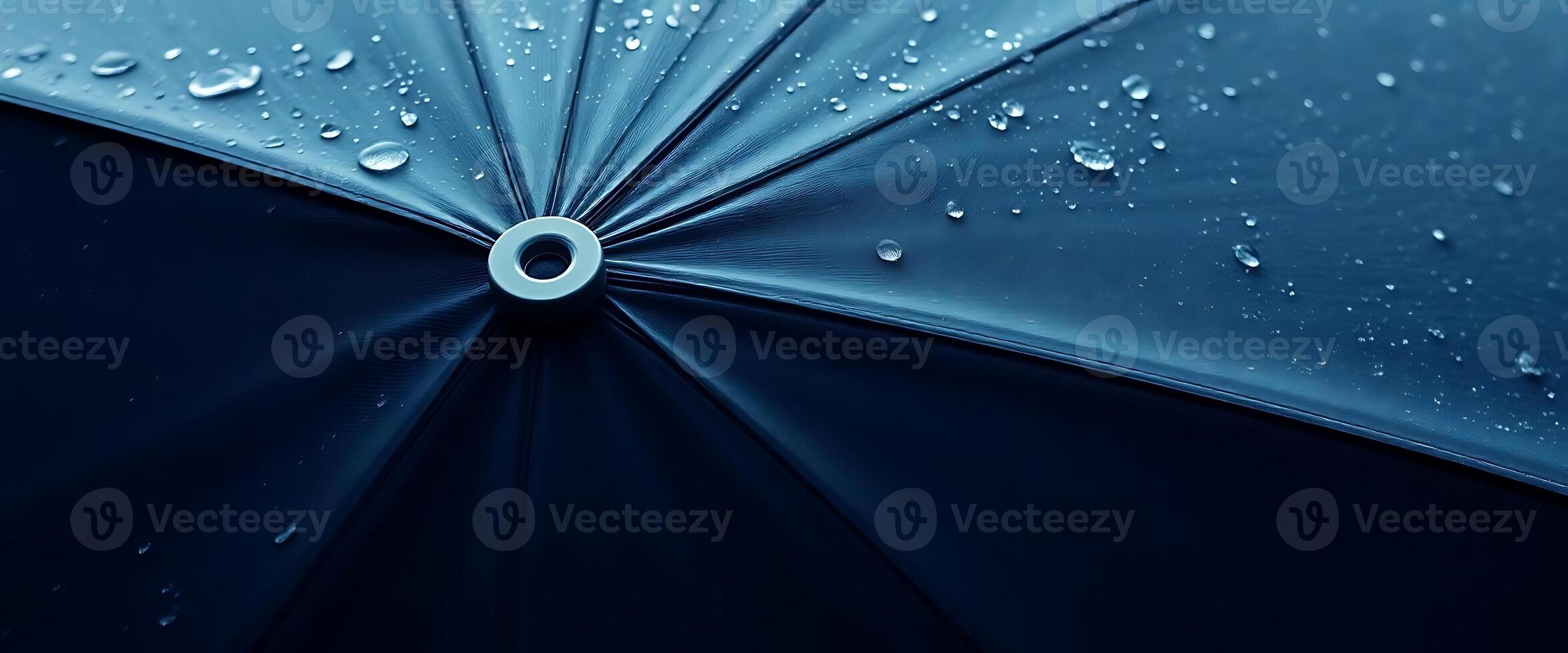 A close up of a blue umbrella with water droplets on it photo