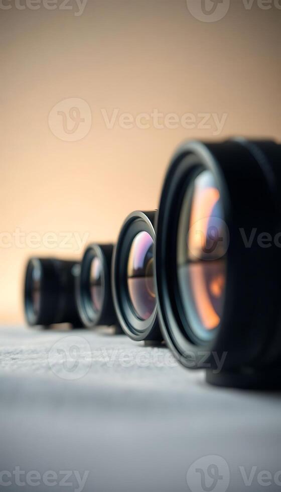 row of camera lens sitting on top of a table photo