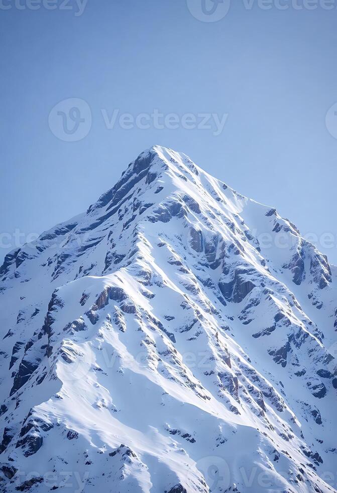 A snow covered mountain with a blue sky photo