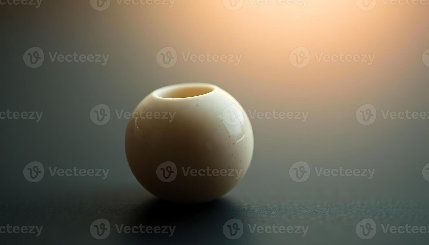 A small white vase sitting on a table photo