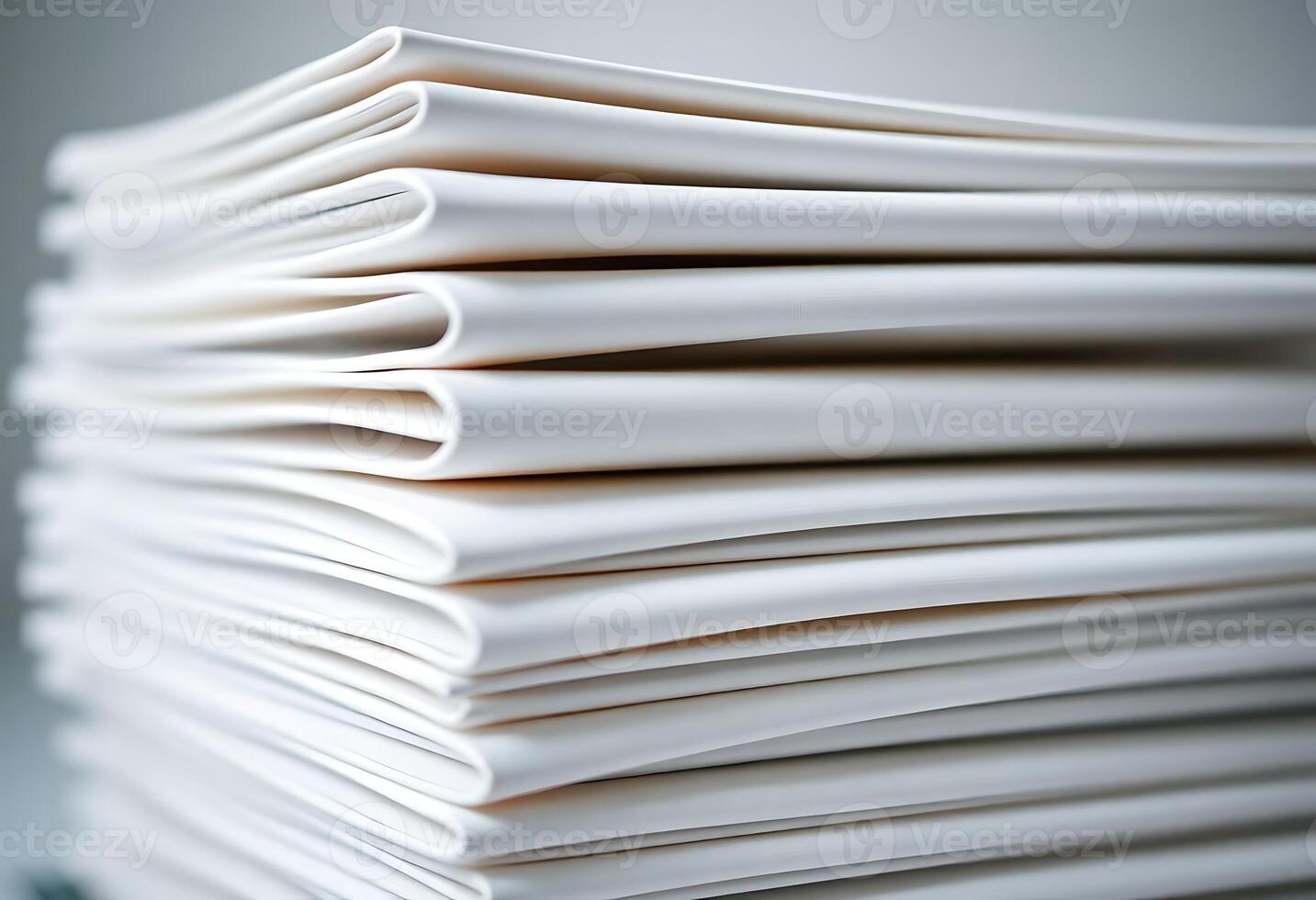 A stack of white papers on a table photo