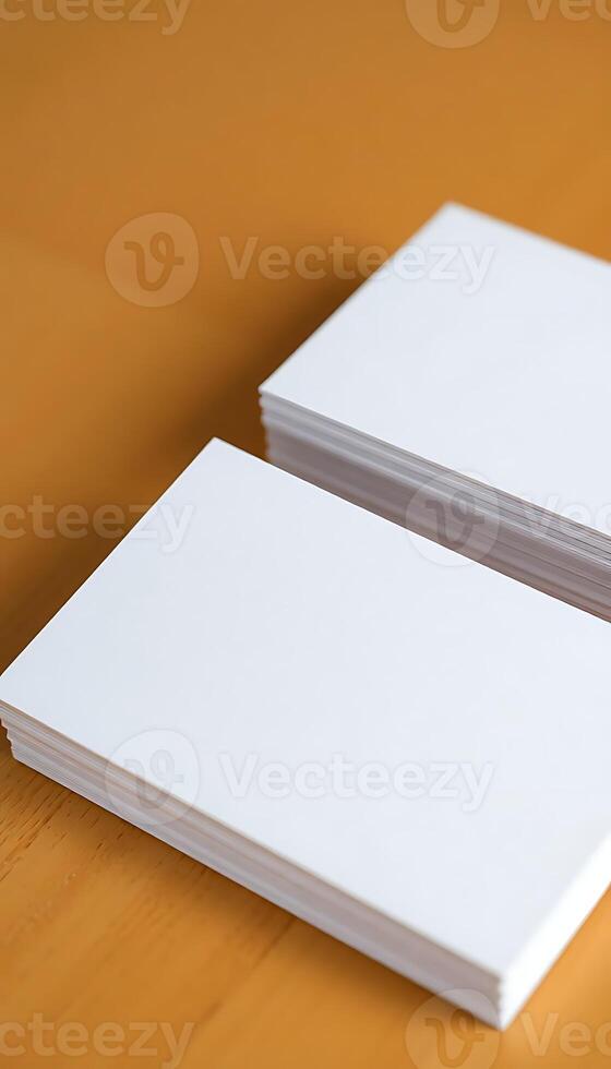 two white business cards sitting on top of a wooden table photo