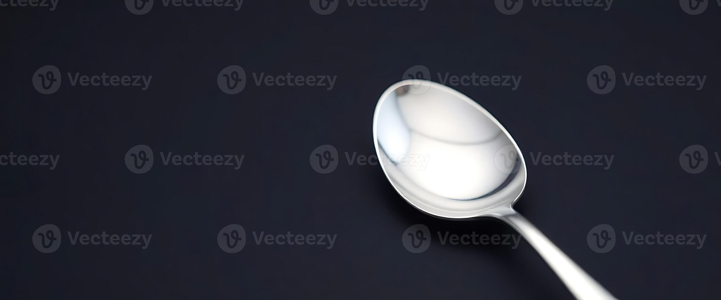 close up of a spoon on a black surface photo