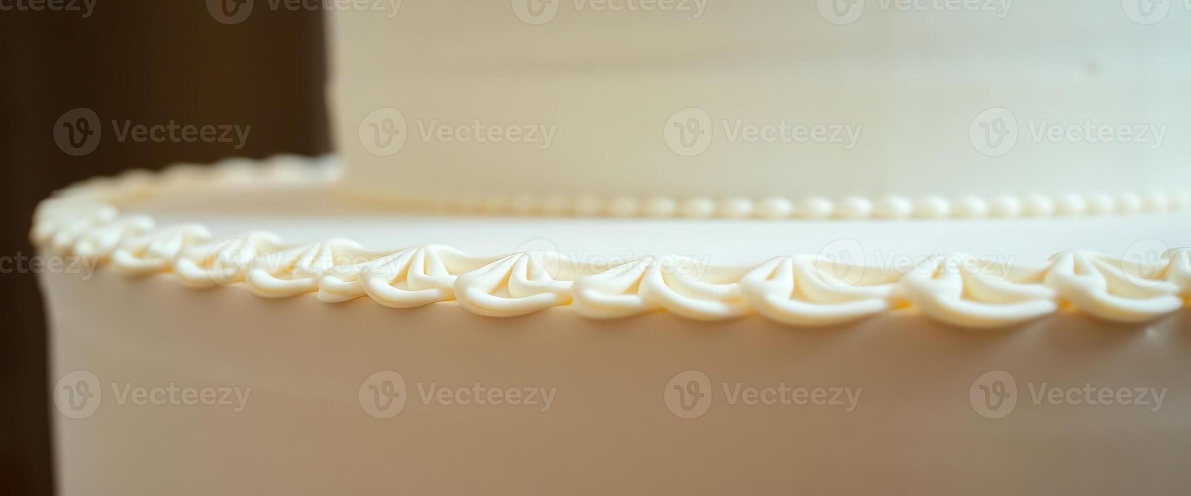A close up of a white wedding cake with a white frosting photo