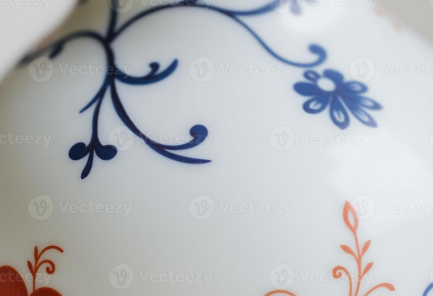 white vase with blue and orange designs on it photo