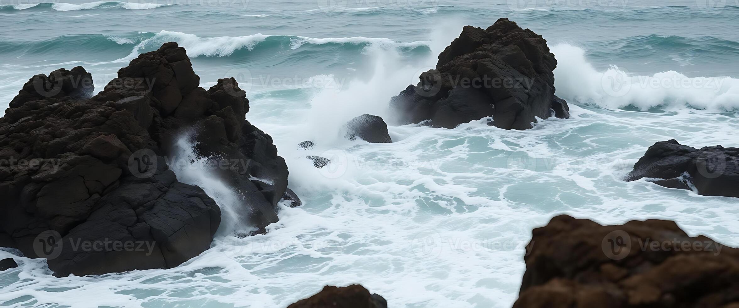 Waves crashing against the rocks at the beach photo