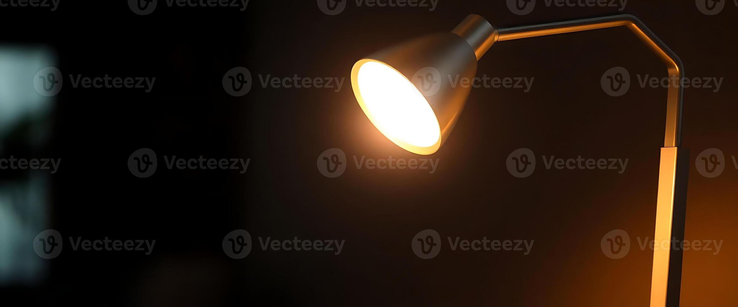 A lamp is on in a dark room photo