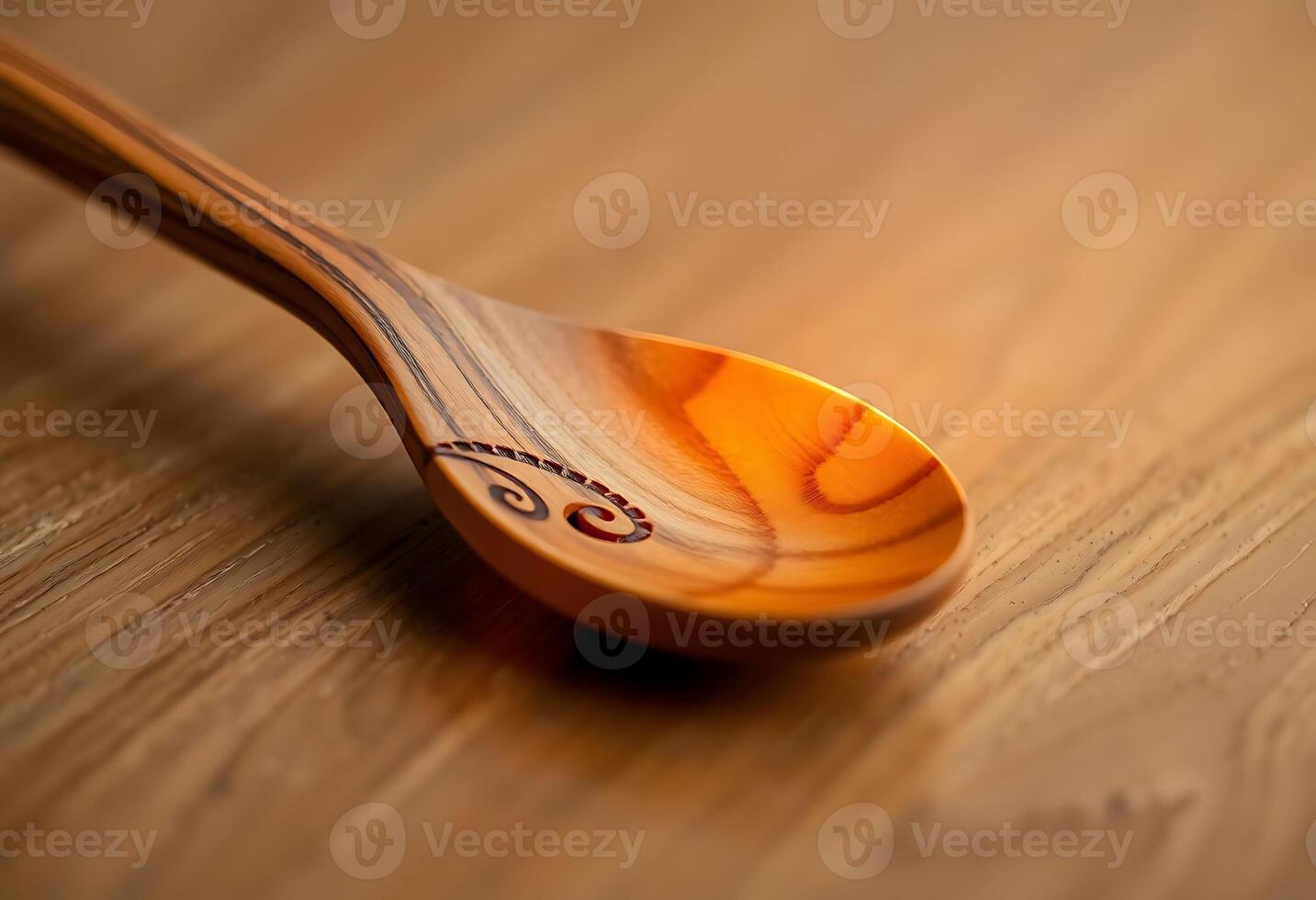 A wooden spoon with a carved design on it photo