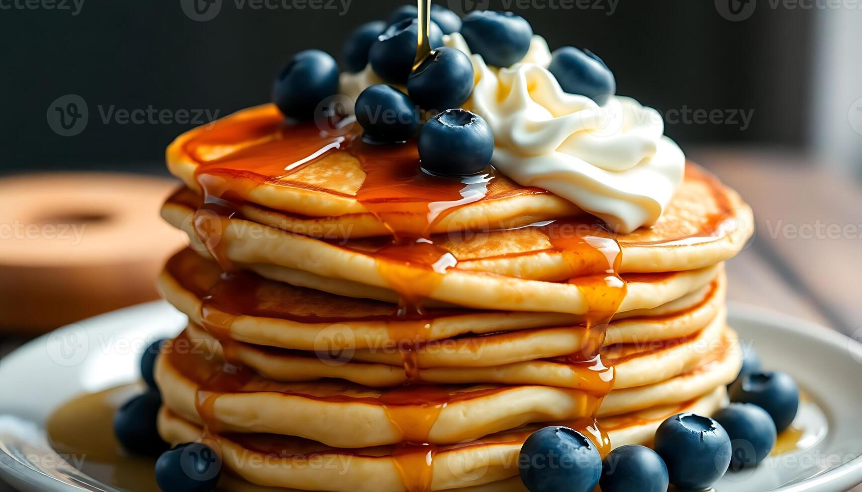 stack of pancakes covered in syrup and blueberries photo
