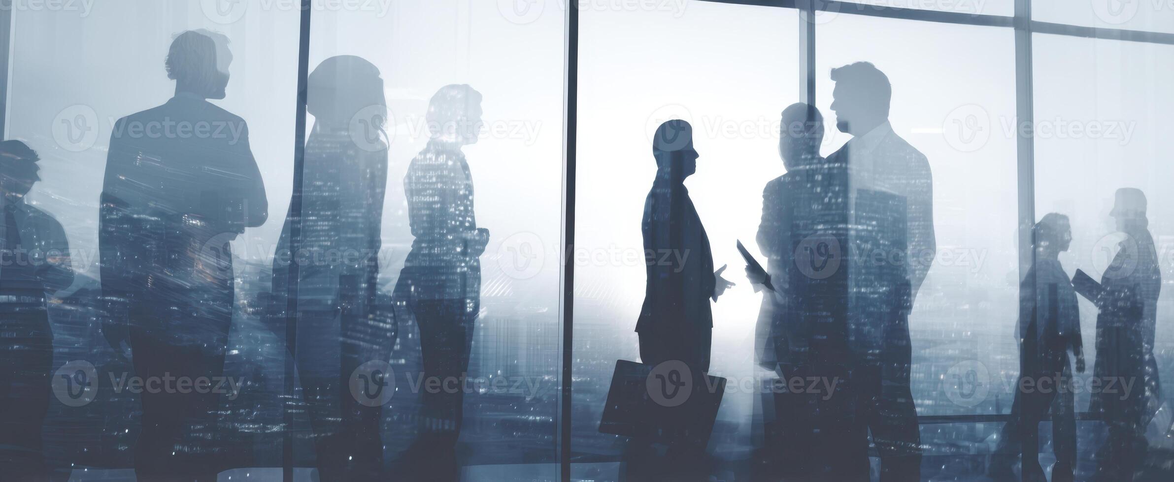 The silhouettes of business professionals engaging in collaboration against a city skyline. photo