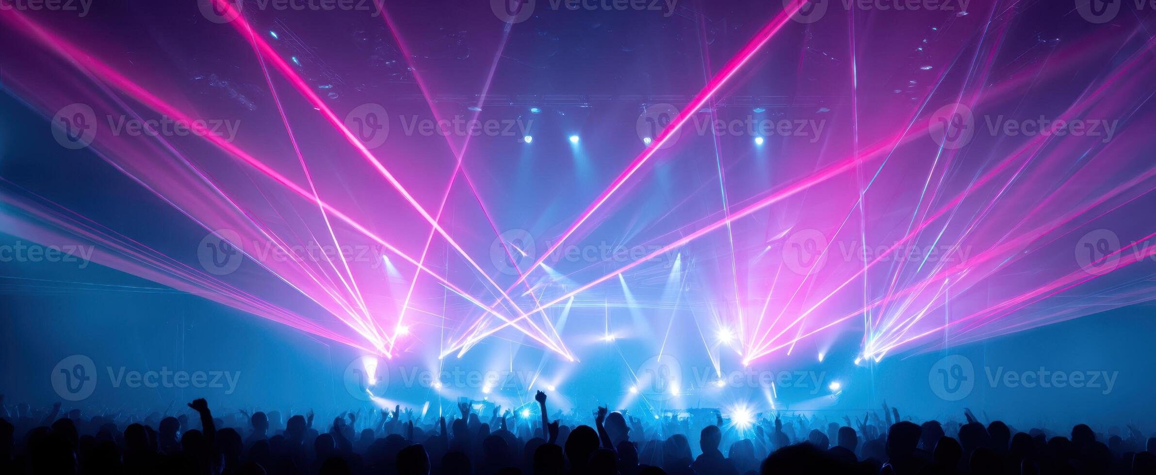 The vibrant lasers illuminate the crowd at an electrifying concert performance. photo