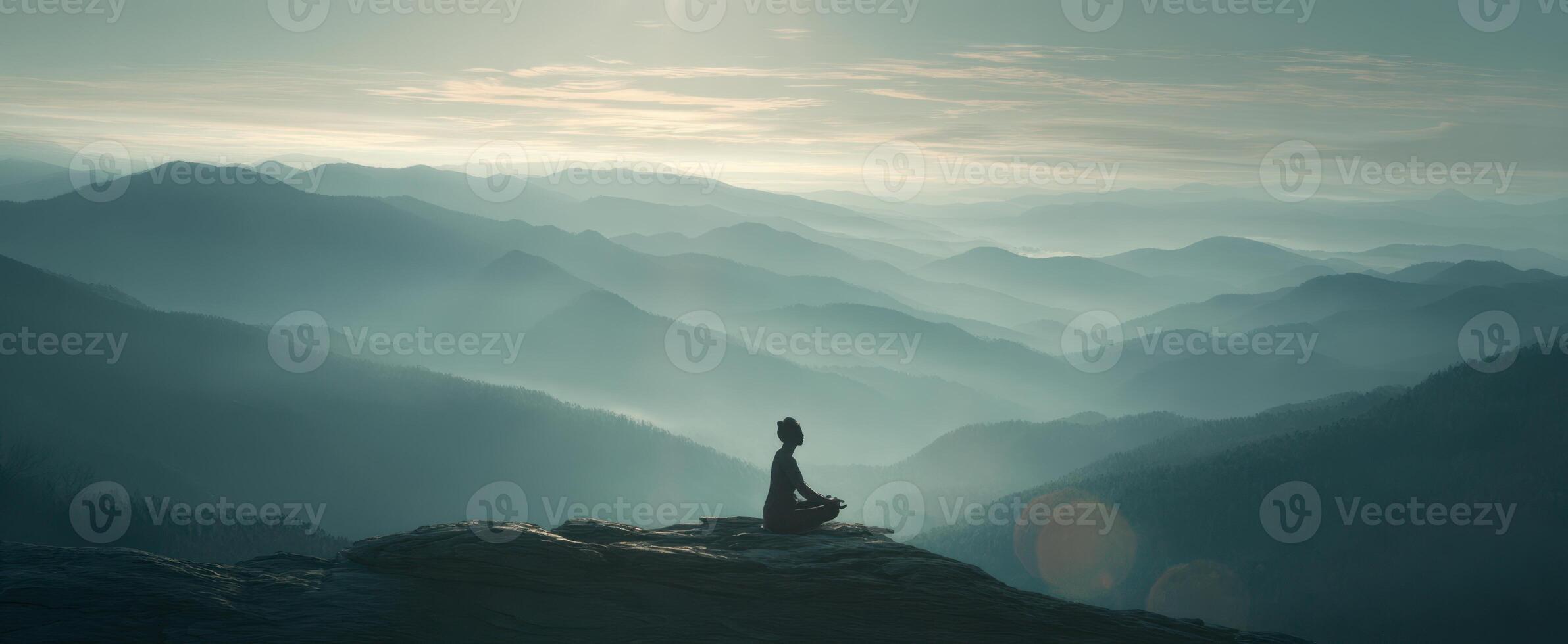 The serene moment of meditation overlooking misty mountain landscapes photo
