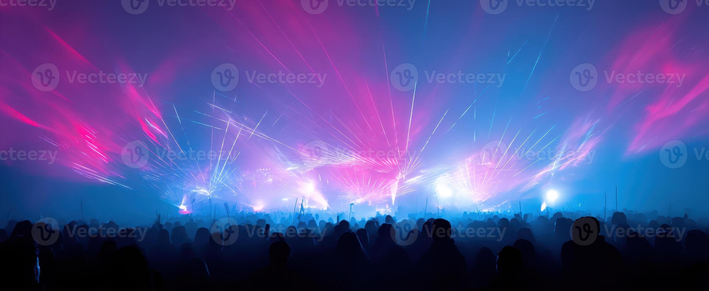 The vibrant energy of a concert illuminated by colorful laser lights. photo