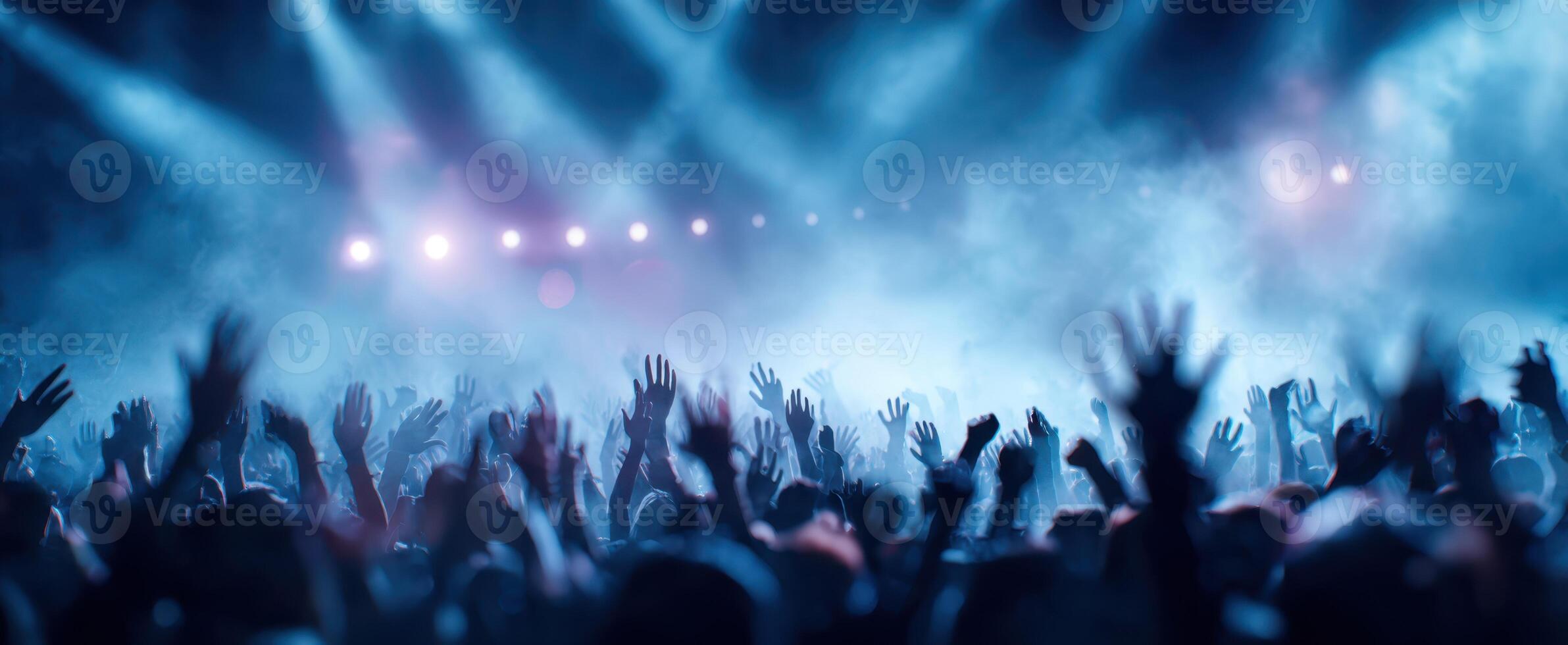 The Enthusiastic Crowd Raising Hands at a Lively Concert Event photo