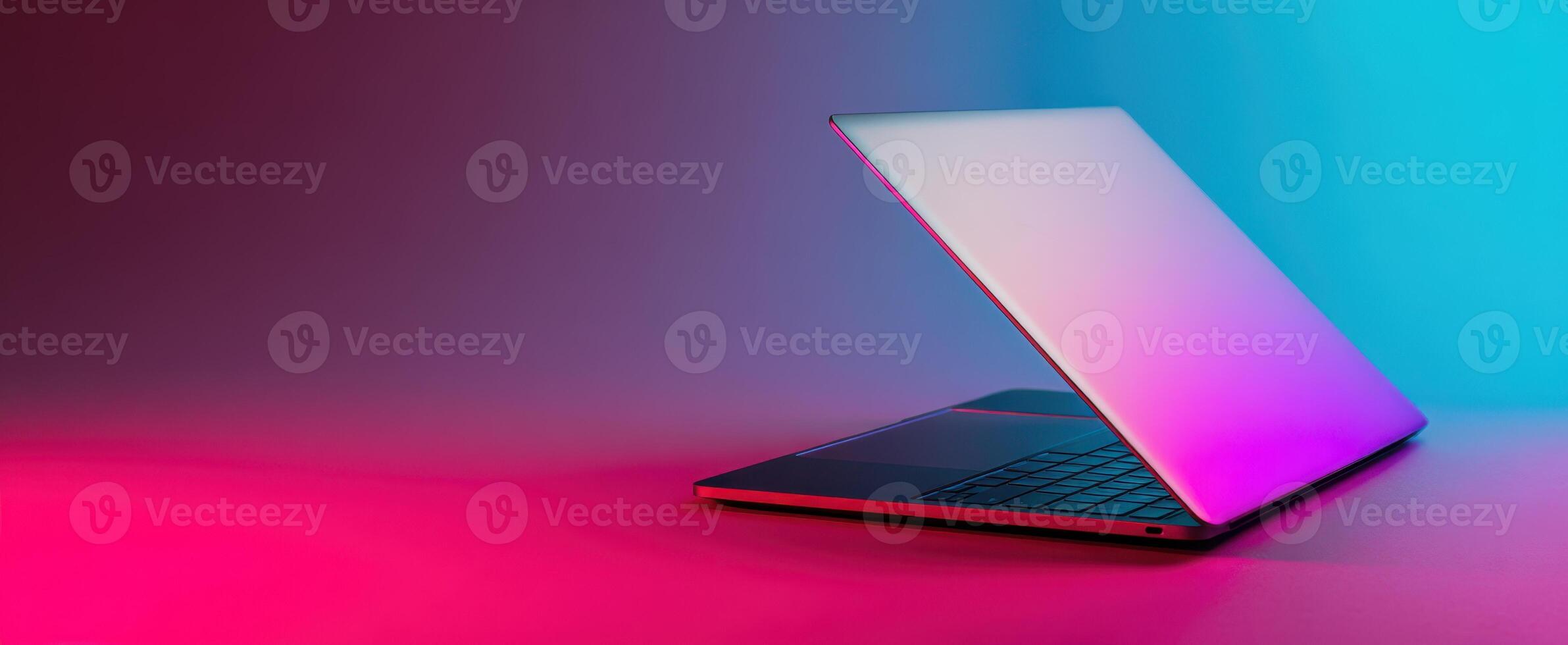 The modern laptop showcasing a sleek design with vibrant gradient lighting. photo