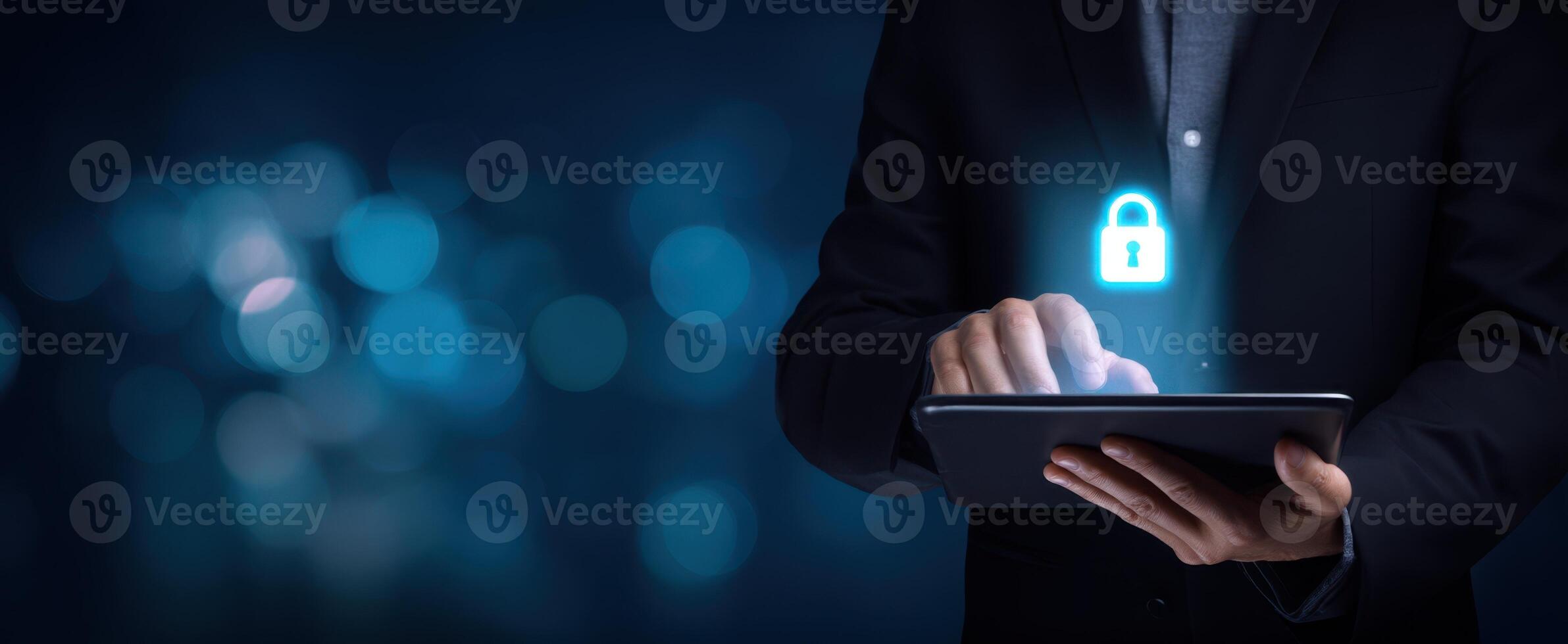 The businessman using a tablet with a glowing lock symbol for security. photo