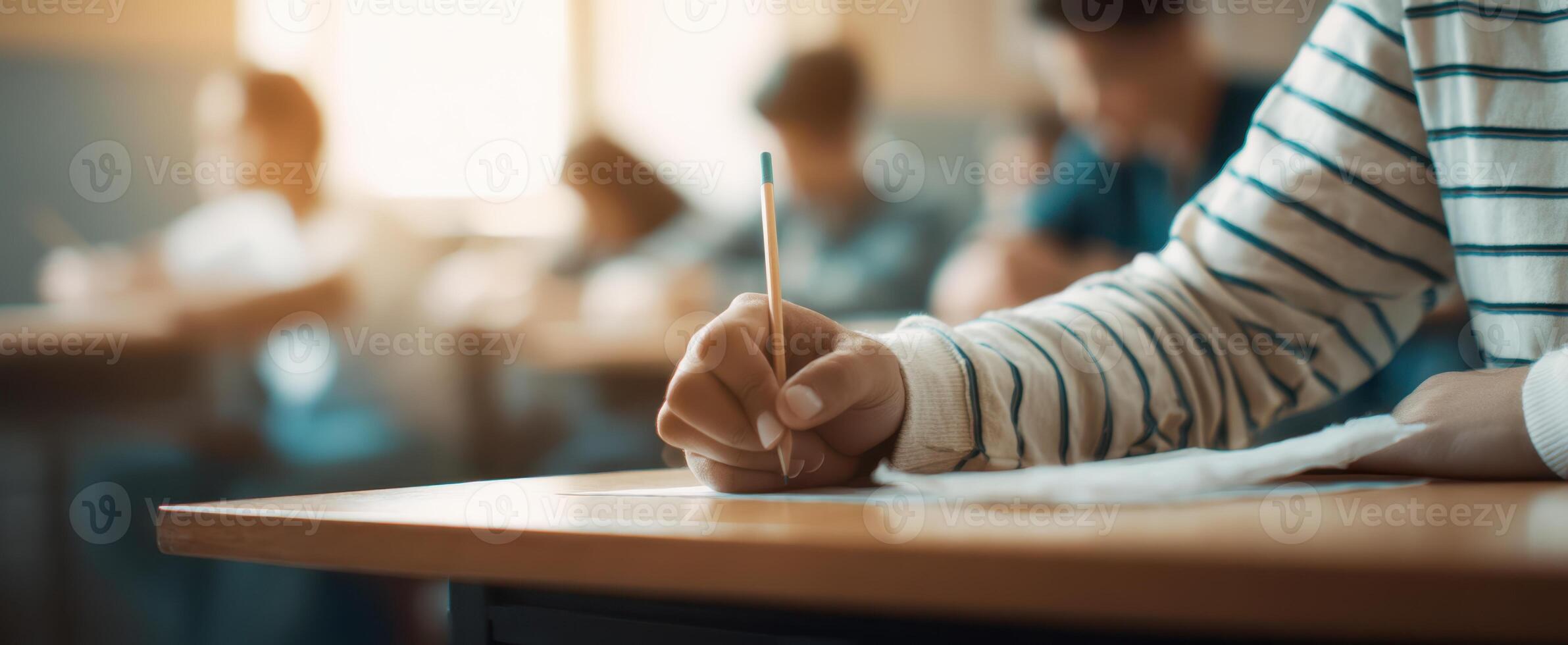 The Student Writing During an Exam in a Bright Classroom Setting. photo