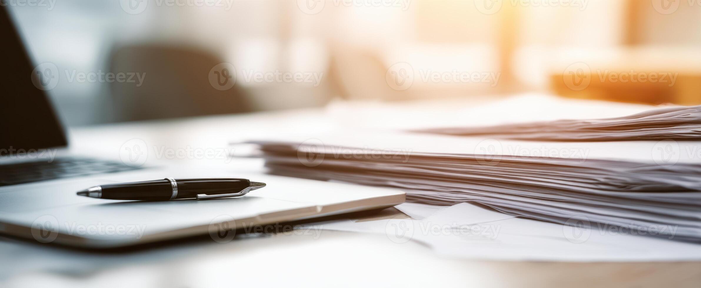 The modern workspace with a laptop, pen, and organized documents on a desk. photo