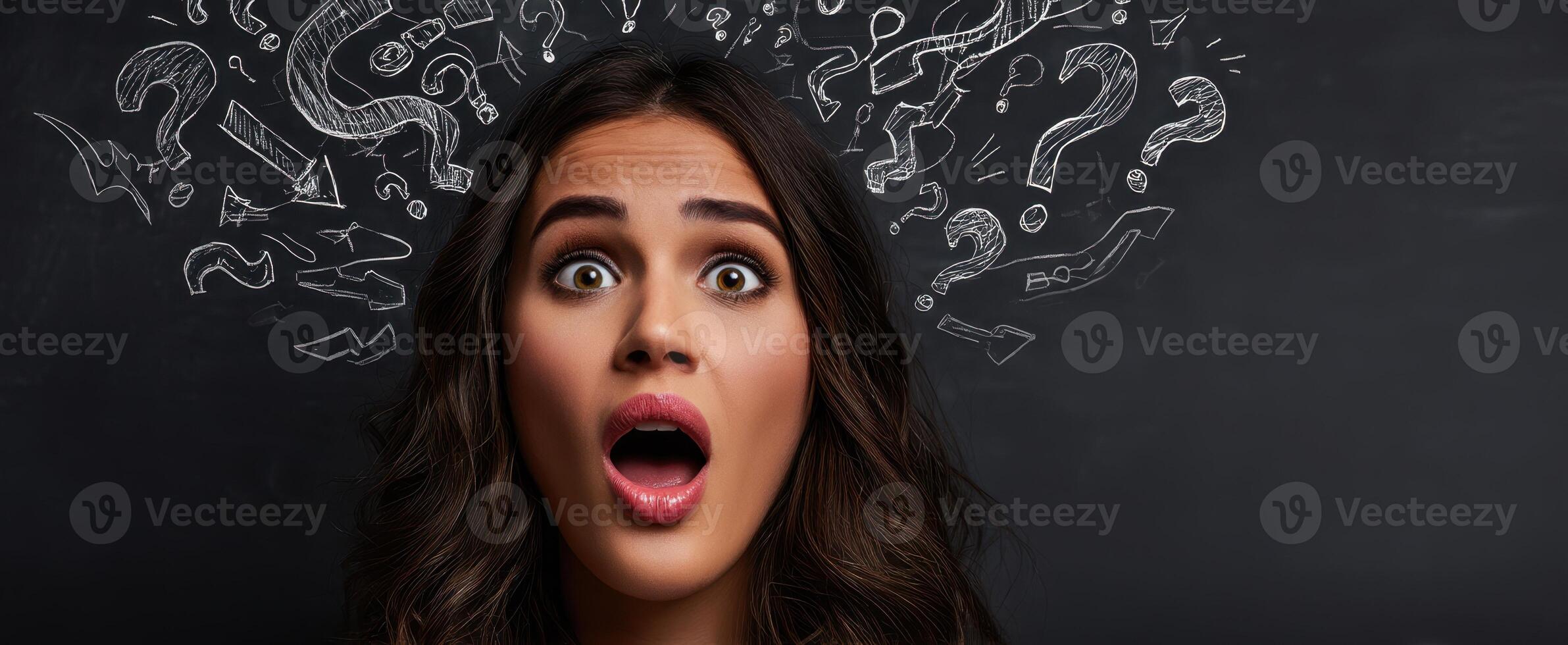 The expressive woman demonstrating confusion and surprise with question marks overhead. photo