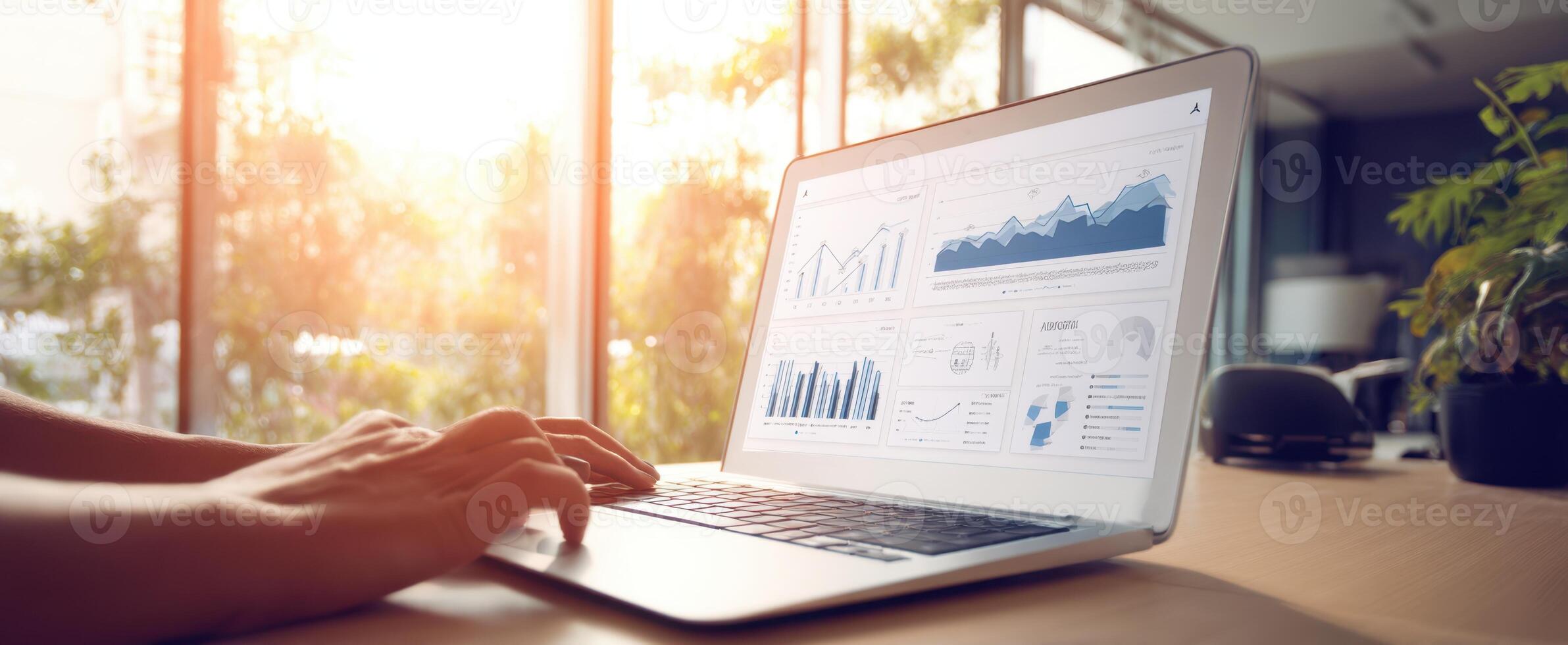 The laptop displaying data analytics in a bright and modern workspace. photo