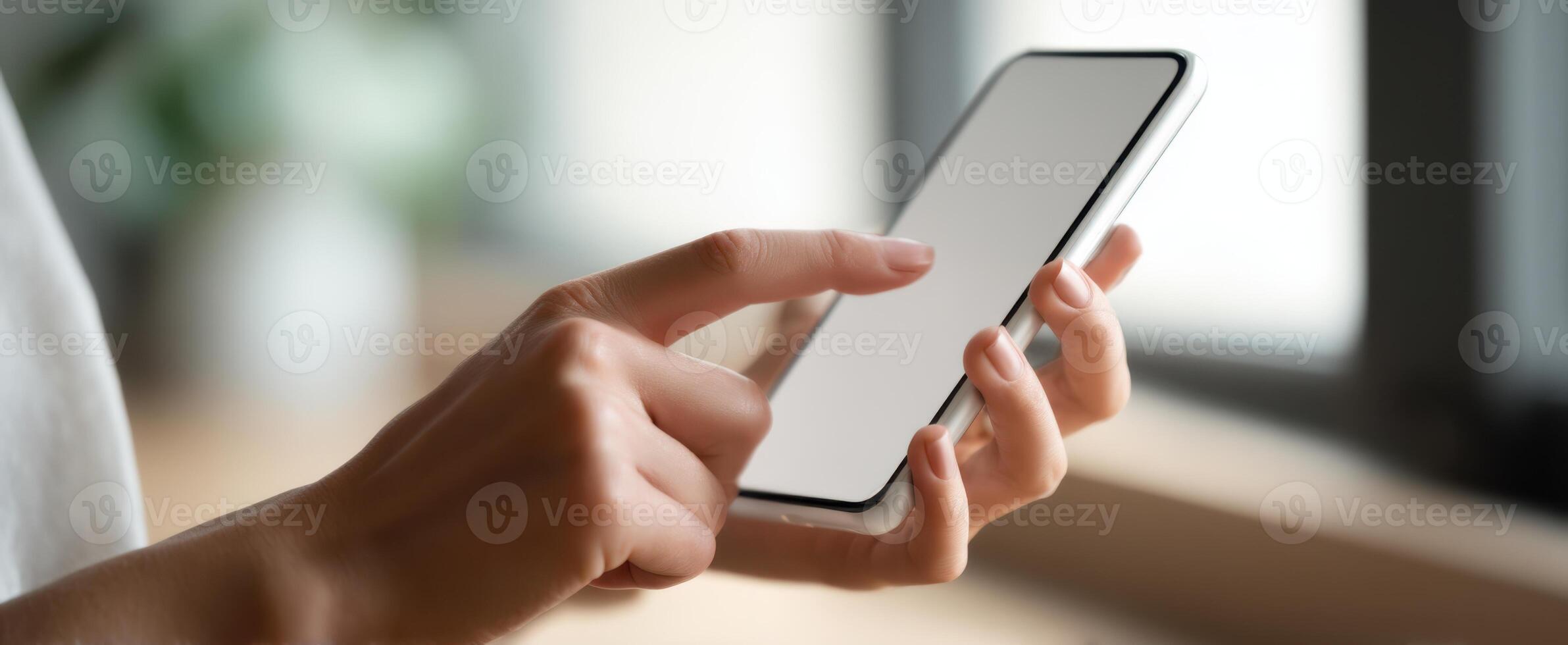 The hands of a person interacting with a modern smartphone in a cozy setting. photo