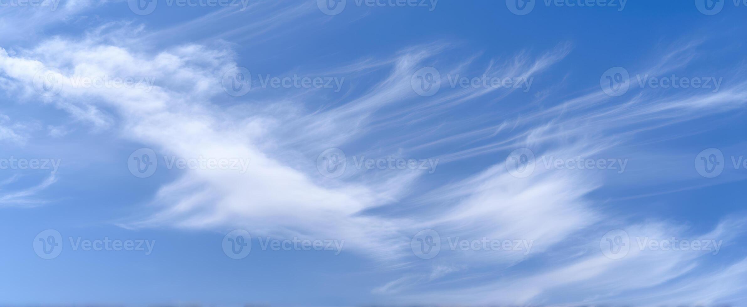 The Soft Wisps of Clouds Against a Clear Blue Sky photo