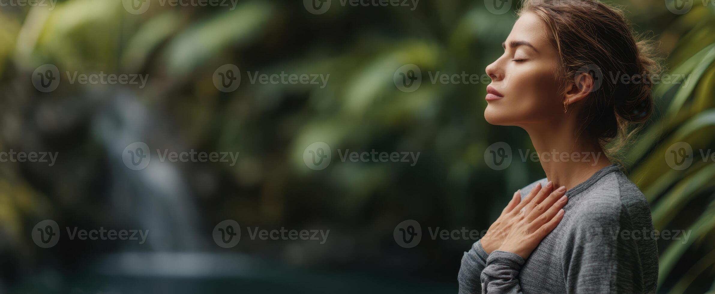 The woman enjoying a serene moment of mindfulness by a tranquil waterfall. photo