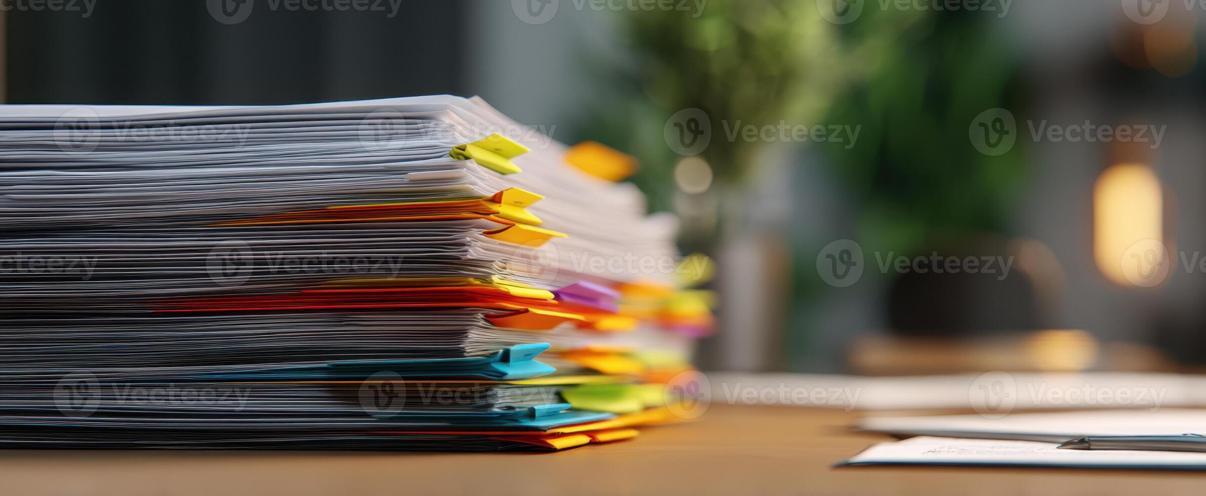 The organized stack of colorful documents on a modern office desk photo