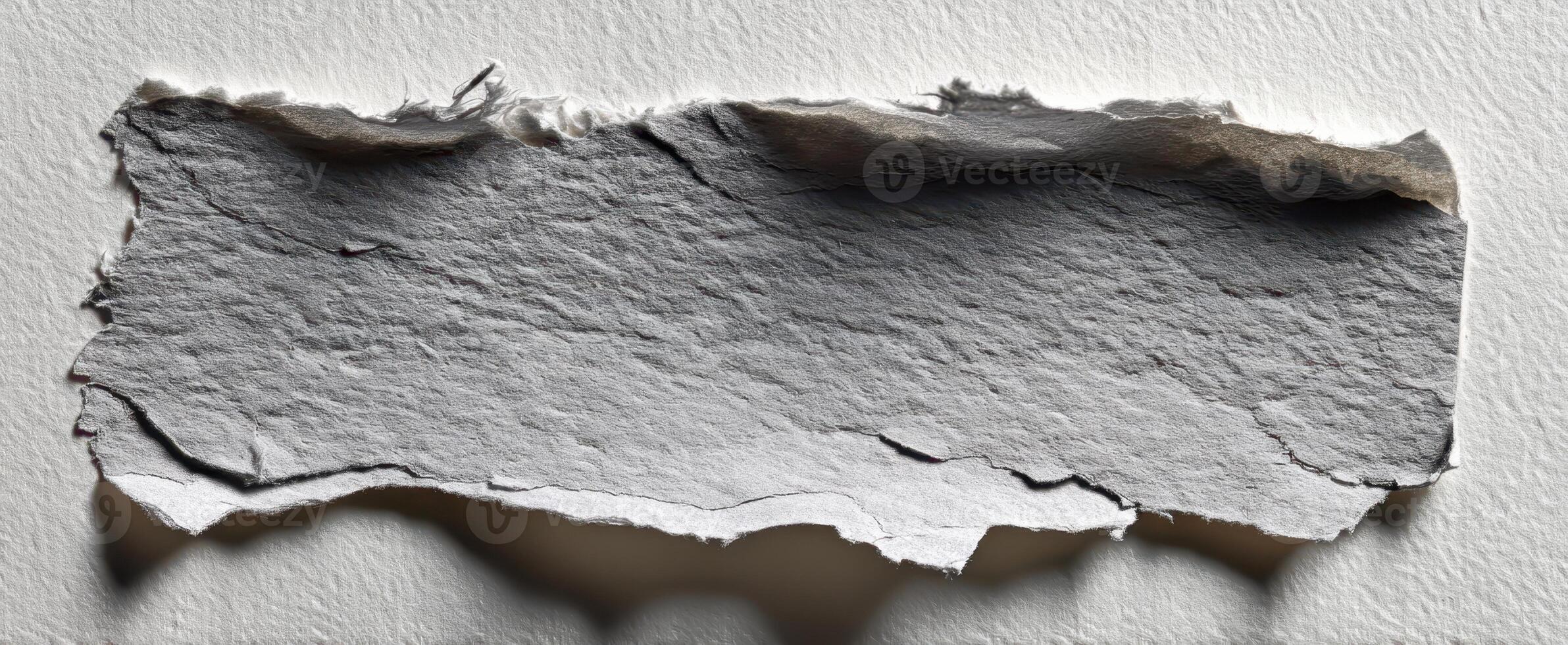 The textured appearance of torn paper on a white background for creative projects photo