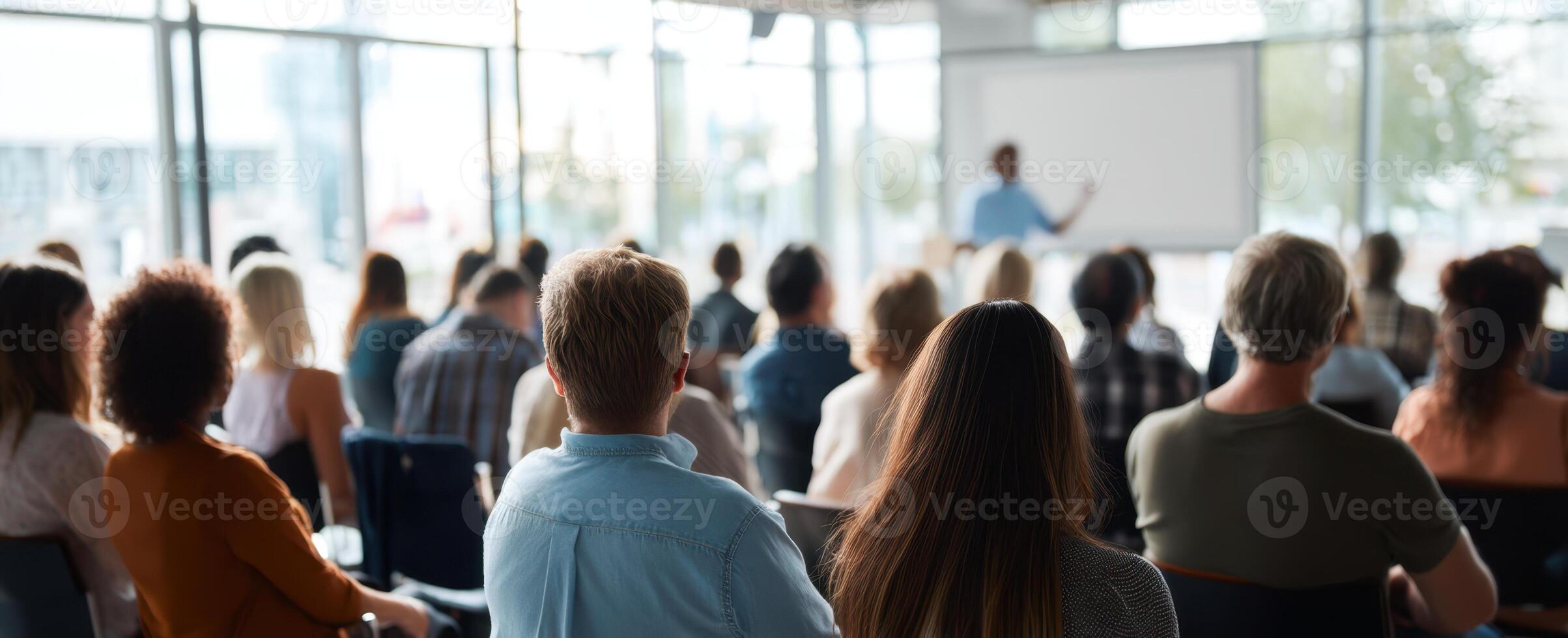 The engaged audience listening attentively during a professional presentation in a seminar. photo