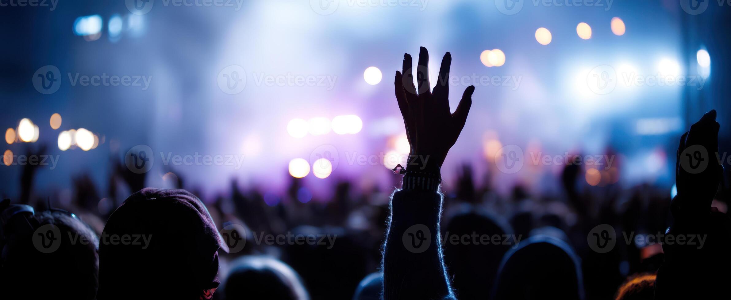 The vibrant atmosphere of hands raised at a lively concert event. photo