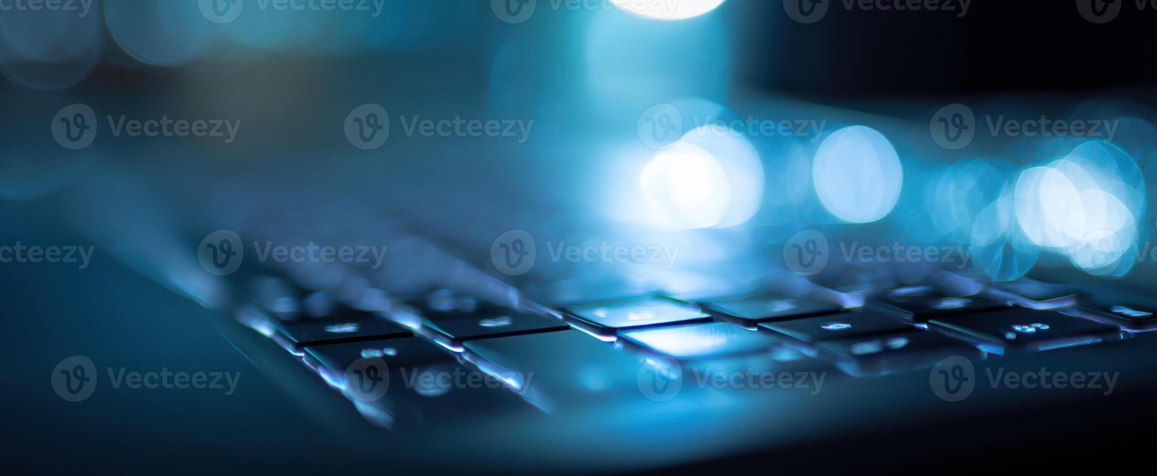 The Close-Up of a Backlit Keyboard with a Soft Blue Glow photo