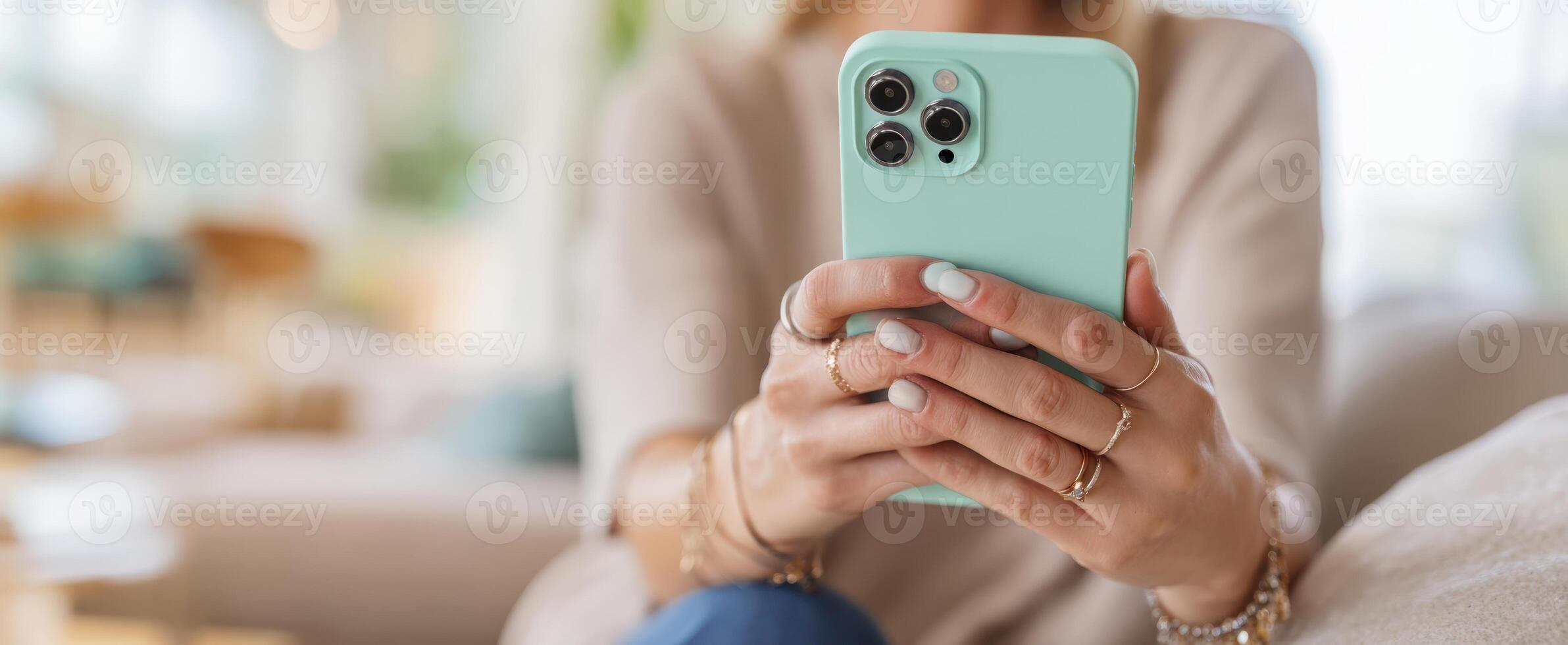 The woman relaxing at home while using a smartphone in her hands. photo