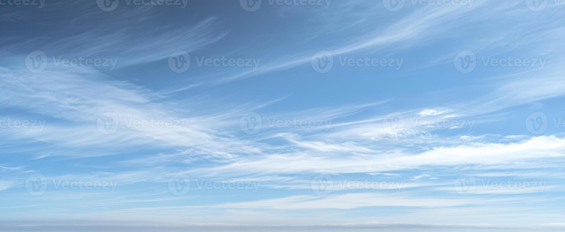 The serene sky with wispy clouds creating a tranquil atmosphere photo