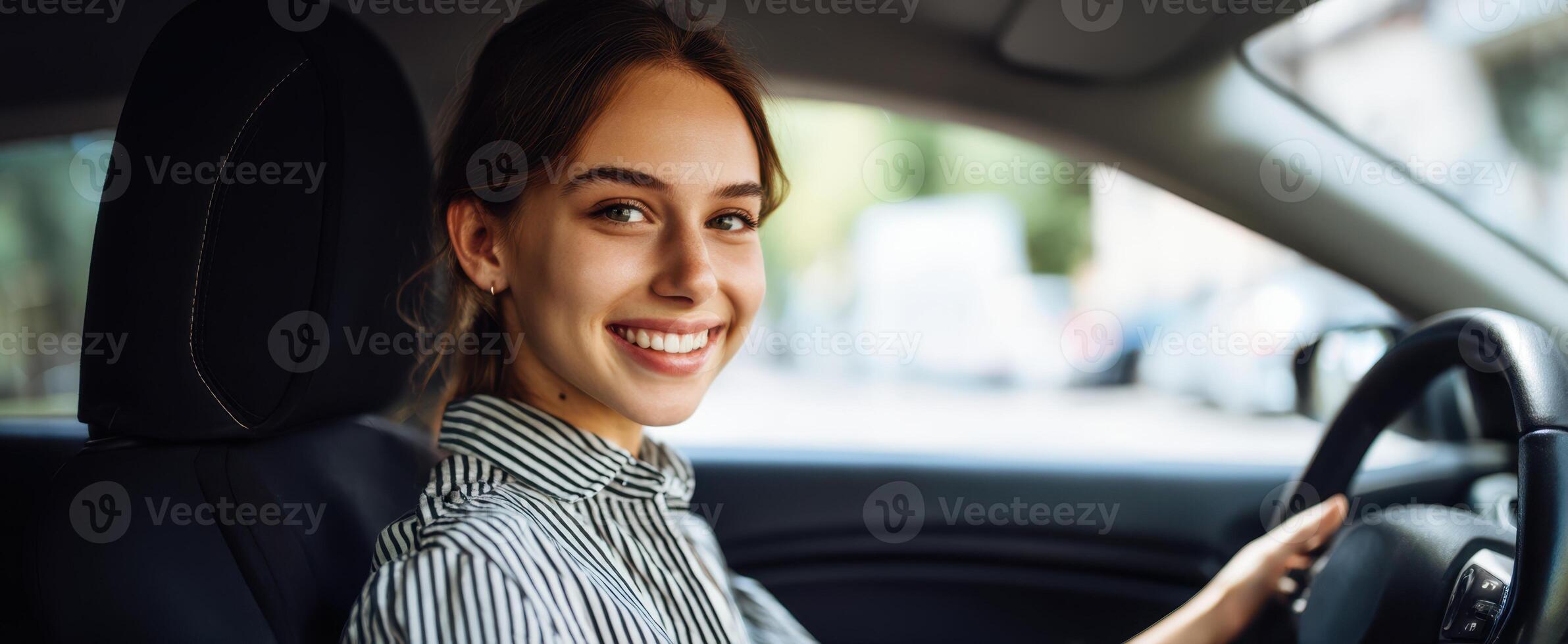 The joyful woman enjoying a drive in her stylish automobile. photo