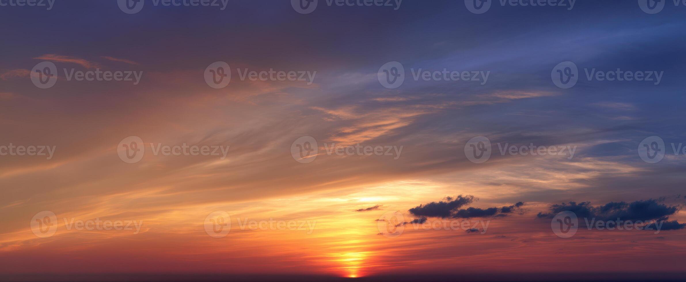 The stunning sunset over the horizon with vibrant colors and dramatic clouds. photo