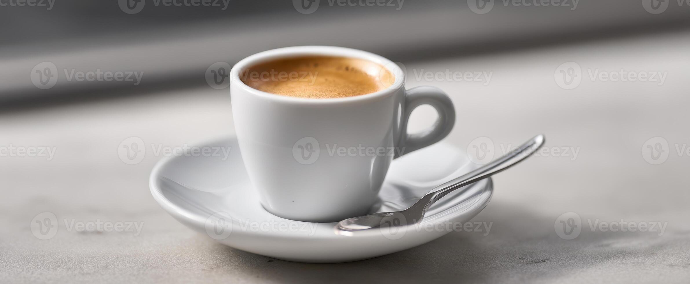 The elegant espresso cup on a simple saucer with a spoon. photo