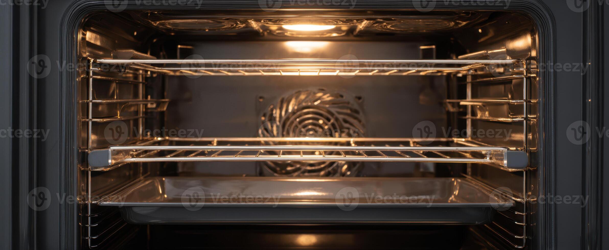 The modern oven interior with spacious racks and warm lighting. photo